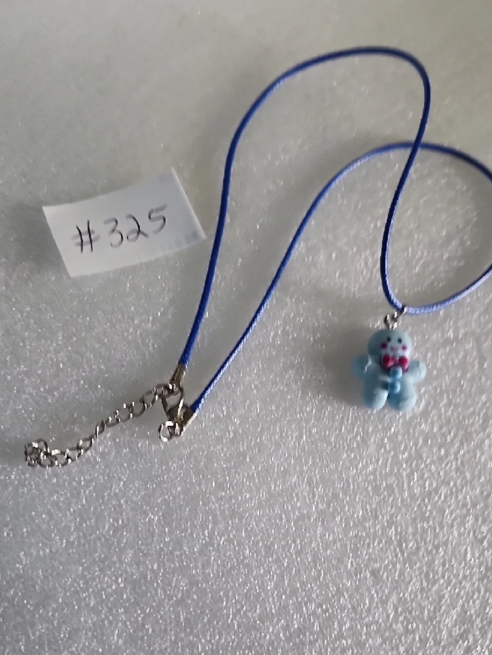 Hand Crafted Blue Gingerbread Man Necklace with Pink Bow